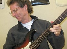 Mike
                Hutchens plays guitar